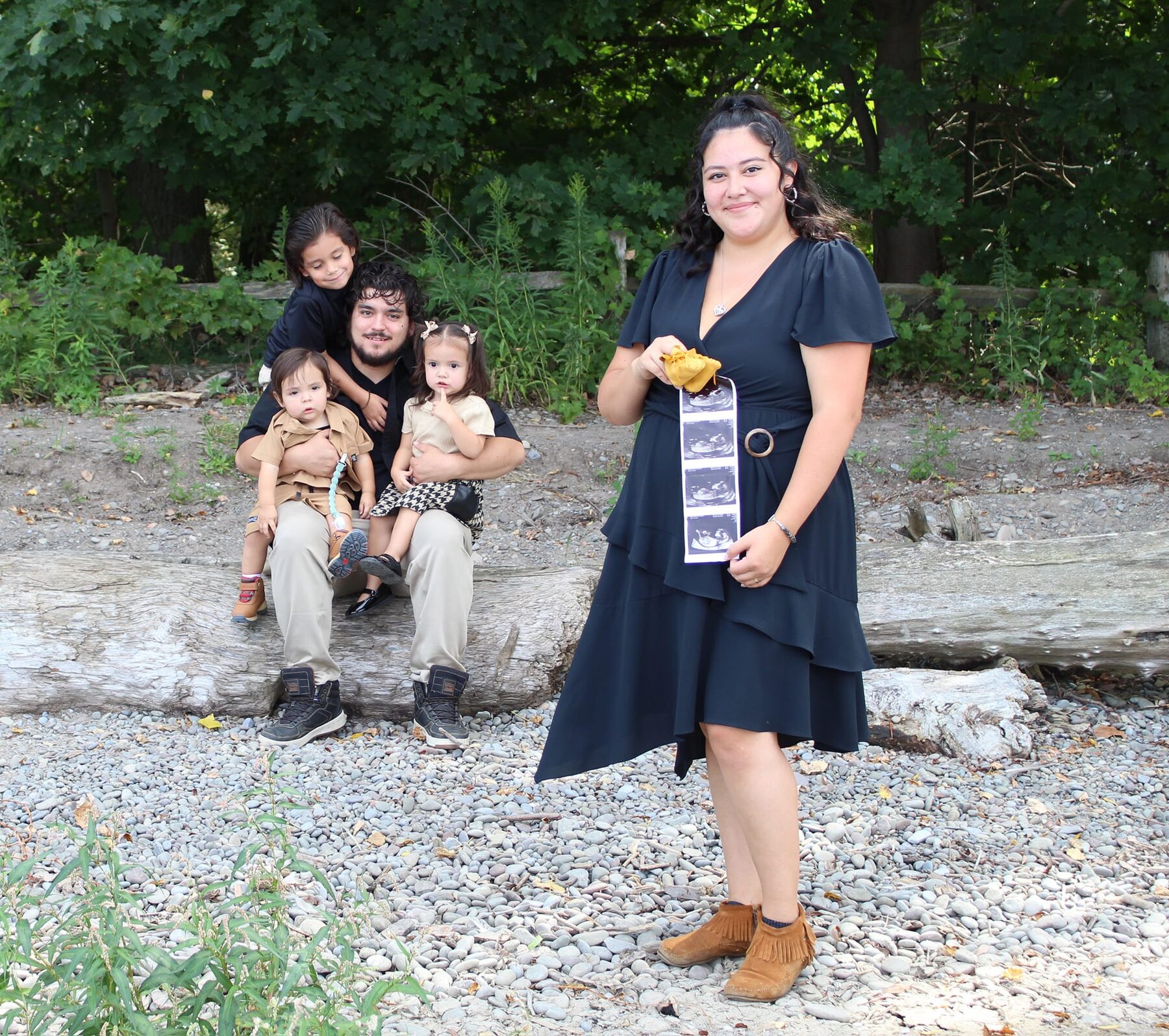 Graduate celebrating with her children on the lakeshore
