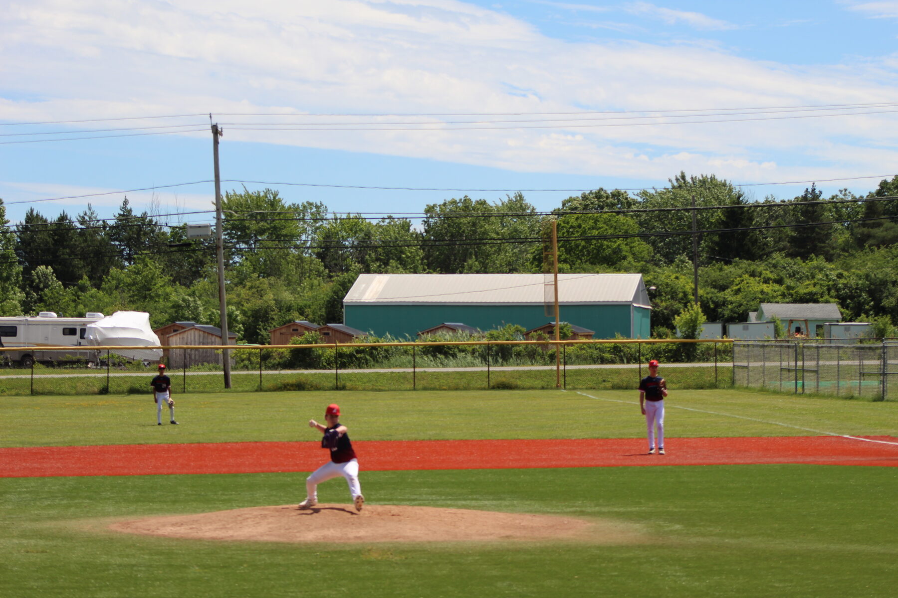 Wide view of a youth baseball diamond in late day light