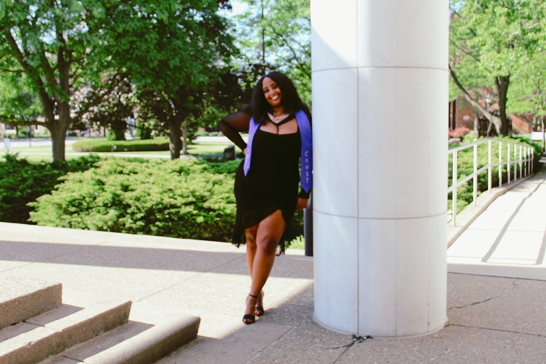 Graduation portrait framed by tall white columns